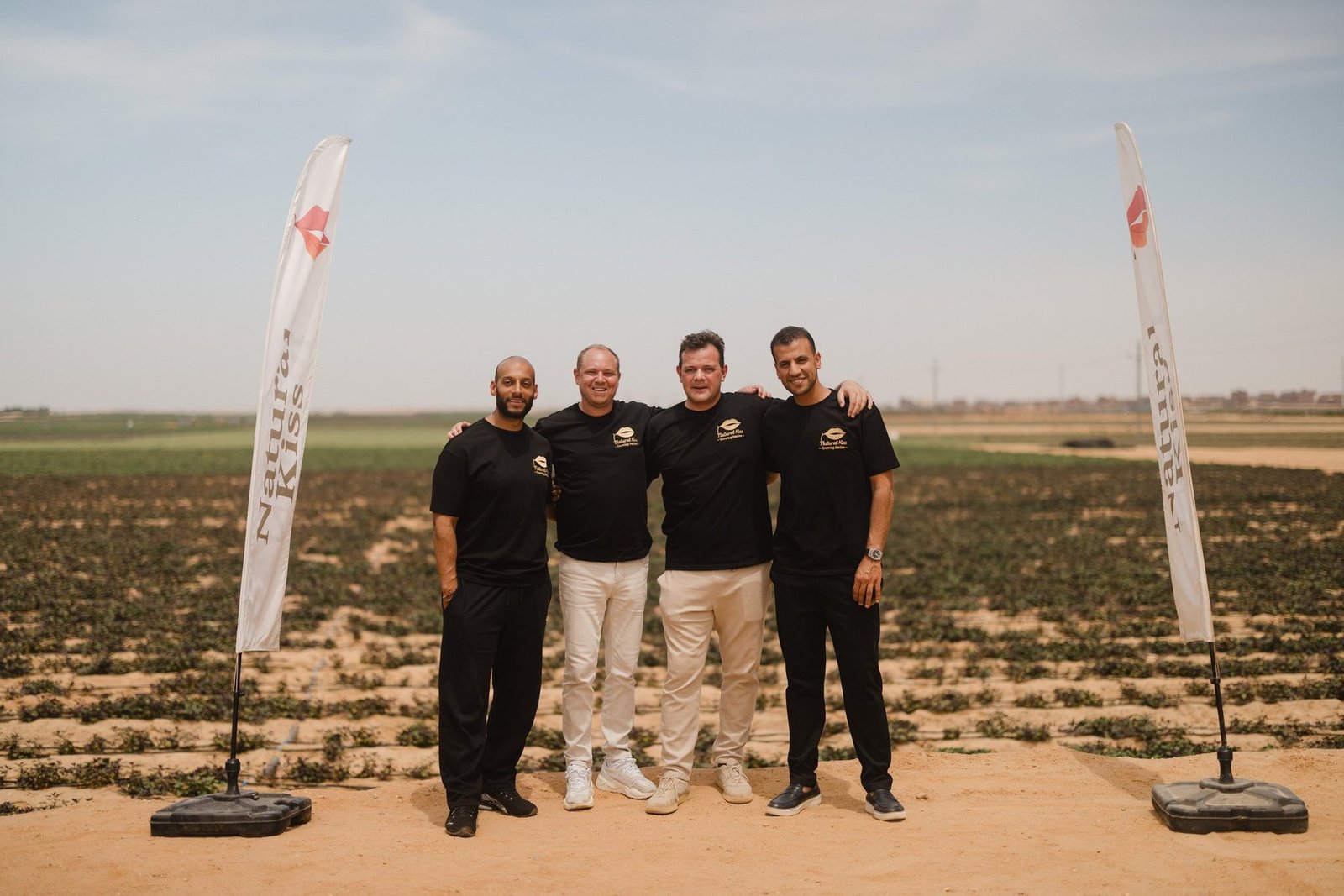 The four founders of Natural Kiss together in the fields